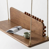 Wooden swing with a magazine and mug on a white background