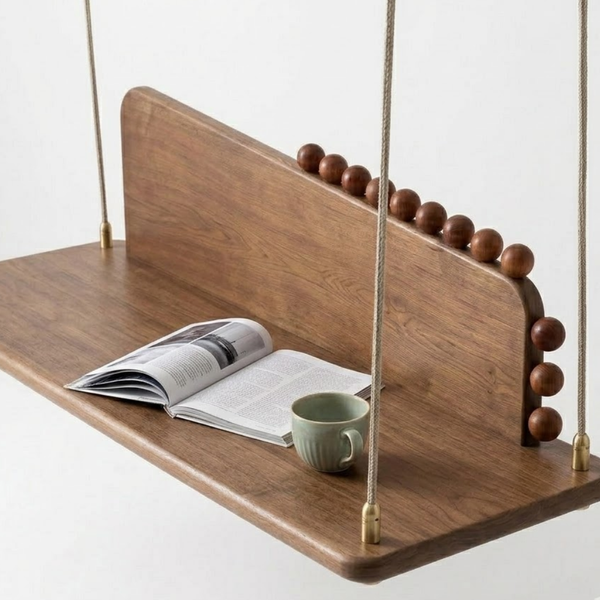 Wooden swing with a magazine and mug on a white background