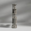 Tall, cylindrical architectural model on a gray background
