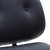 Close-up of a black tufted leather or faux-leather chair back with a small button tuft and a white background.