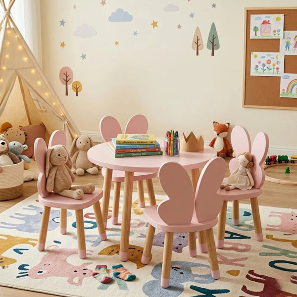 Children's playroom with pink table and chairs, toys, and wall decorations.