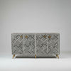 Cabinet with geometric pattern and gold handles on a gray background