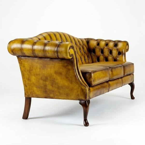 A classic Chesterfield-style leather armchair in a distressed mustard yellow finish, featuring deep button tufting, rolled arms, and dark wooden legs, photographed on a seamless white background.