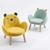 Two children's chairs, one yellow and one green, with animal face designs on a white background.