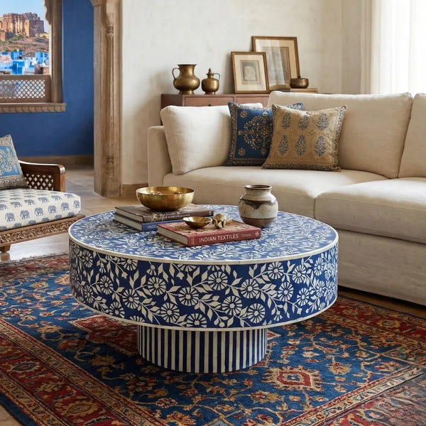 Living room with a round blue and white patterned coffee table, beige sofa, and decorative pillows.