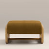 Wooden ottoman with a mustard yellow cushion on a neutral background