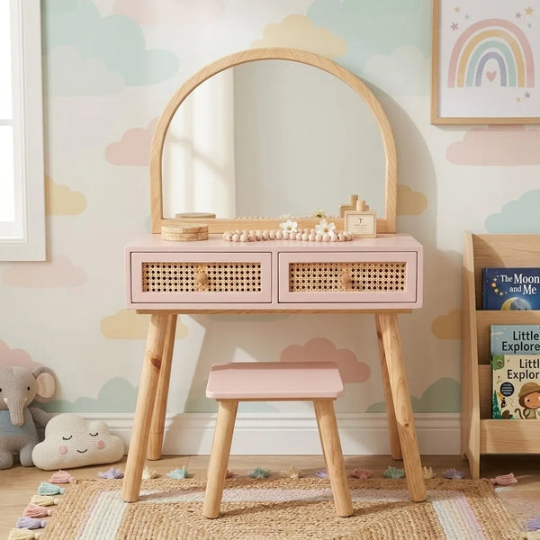 Children's vanity table with mirror and stool against a colorful wall with rainbow and cloud patterns.