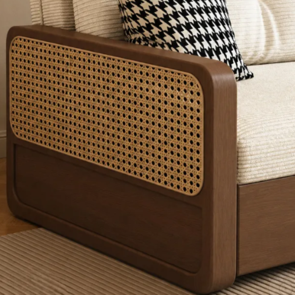 Brown wicker headboard against a white sofa with a black and white patterned pillow.