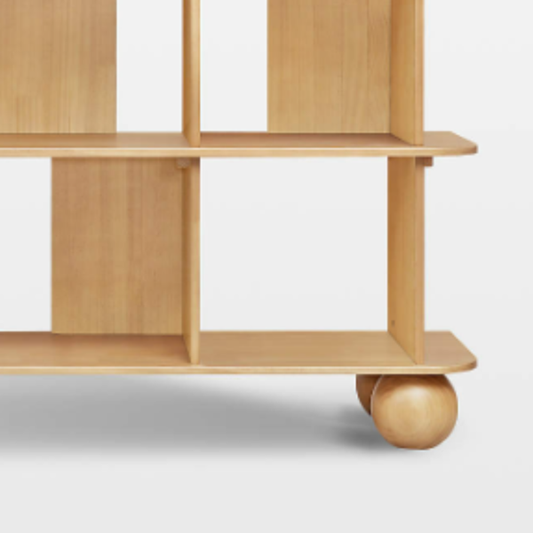 Wooden shelf with wheels on a light gray background