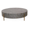 Round coffee tablewith black and white striped pattern and gold legs on a white background