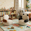 Children's room with panda-shaped chairs, books, and toys.