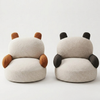 Two plush slippers shaped like cartoon characters on a white background