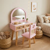 Children's vanity table with mirror, chair, and toys in a room setting.