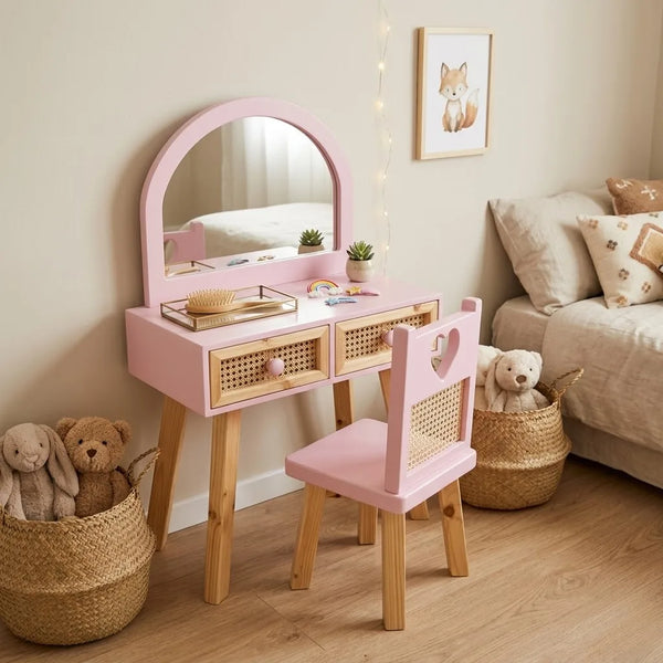 Children's vanity table with mirror, chair, and toys in a room setting.