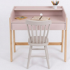Pink children's desk with a white chair on a white background