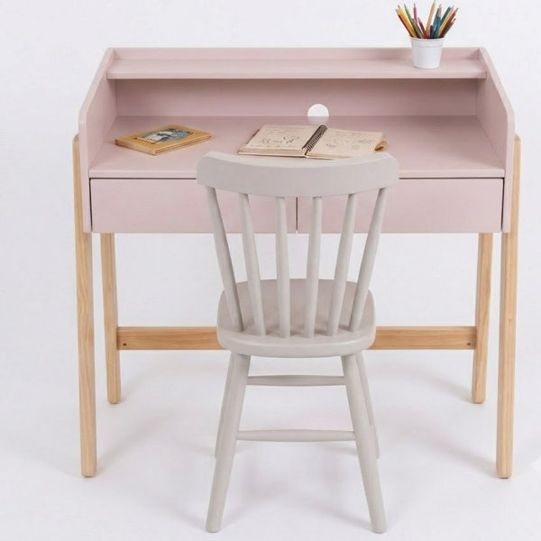 Pink children's desk with a white chair on a white background