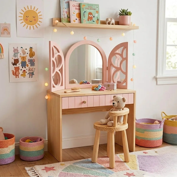 Children's vanity table with mirror, stool, and toys in a room with colorful baskets and wall decorations.