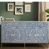 Decorative cabinet with intricate patterns in a room with green walls and framed art.