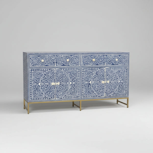 Decorative cabinet with blue and white pattern on a wooden floor.