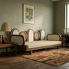 Vintage-style sofa in a room with a abstract painting on the wall and a lamp.