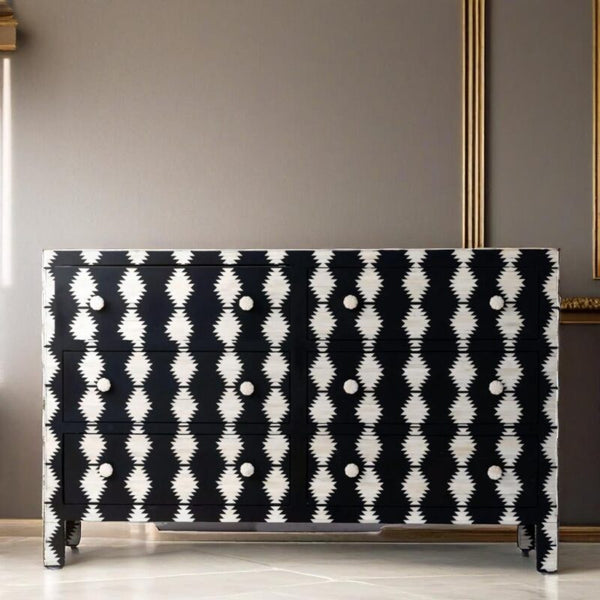 Black and white patterned dresser against a gray wall
