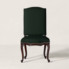 A classic high-back dining chair with a dark forest green upholstered seat and backrest, supported by carved dark brown wooden legs with nailhead trim, set against a plain light beige background.