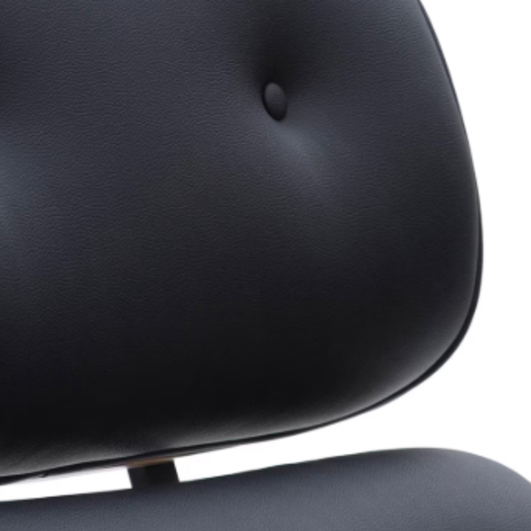 Close-up of a black tufted leather or faux-leather chair back with a small button tuft and a white background.