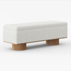 White upholstered bench with wooden legs on a white background