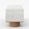 Square ottoman with white textured top and wooden base on a white background