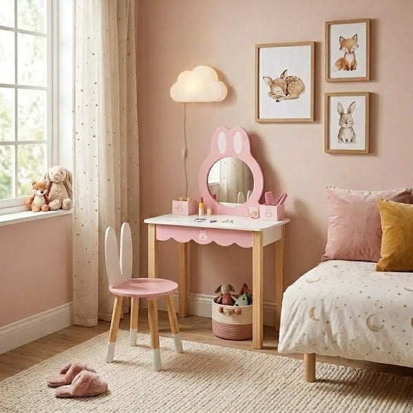 Children's room with pink vanity table, chair, and bed, featuring wall art and toys.