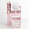 Pink children's vanity table with mirror and shelves on a white background