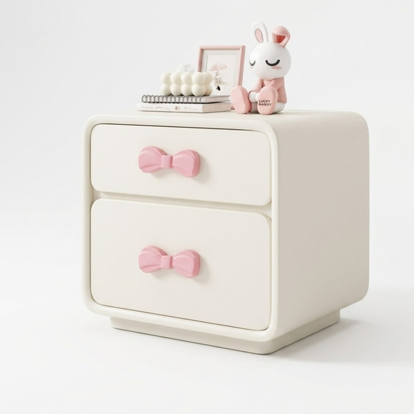 White nightstand with pink bow handles on a white background