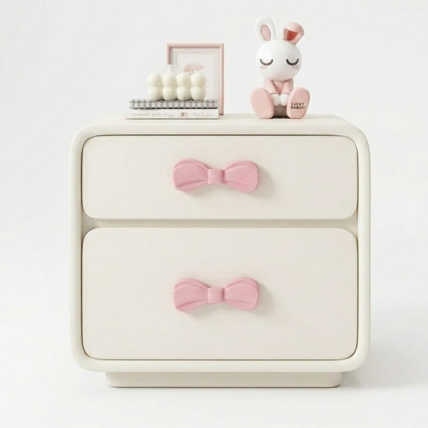 White dresser with pink bow accents on a white background