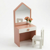 Pink children's vanity table with mirror and chair on a white background