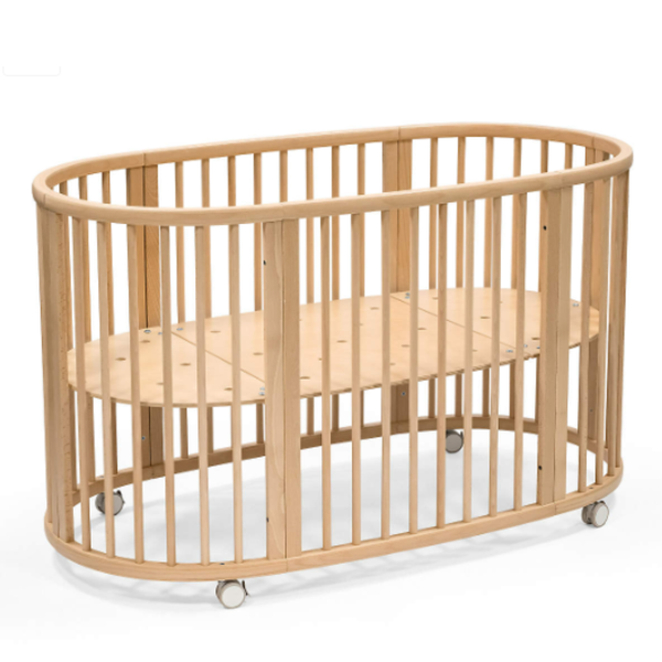 Wooden crib with wheels on a white background
