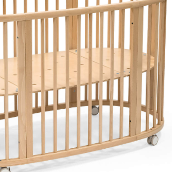 Wooden crib with wheels on a white background