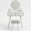 White vanity table with round mirror and gray stool on a white background
