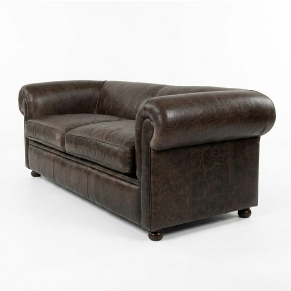 A dark brown leather Chesterfield-style loveseat sofa with rolled arms and dark wooden feet, photographed on a seamless white studio background.