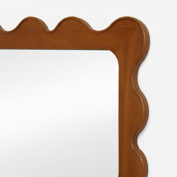 Wooden mirror frame with wavy design on a white background