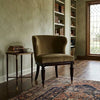 Solid wood curved accent chair ,upholstered with soft velvet fabric in camel color .