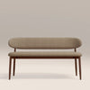 Beige bench with wooden legs on a plain background