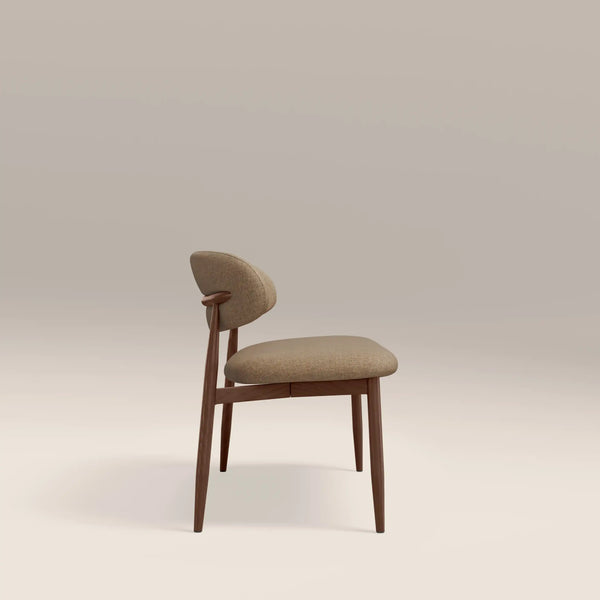 Beige chair with wooden legs on a light beige background