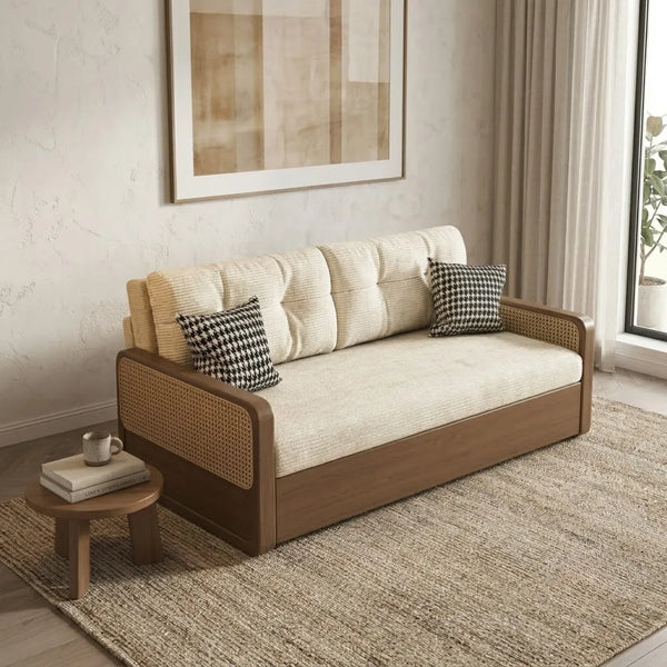 Beige sofa with wooden frame in a room with a small table and decorative pillows.