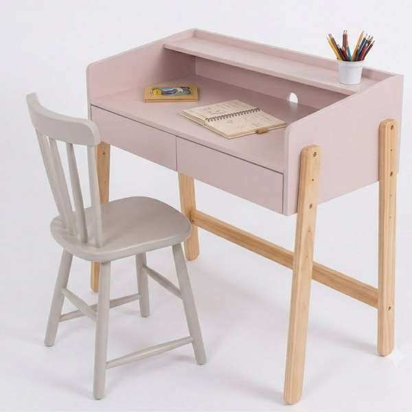 Pink children's desk with wooden legs and a gray chair on a white background