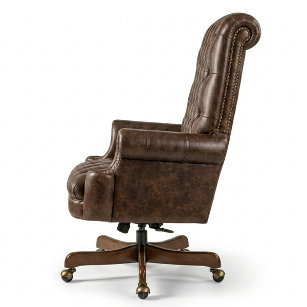 A brown faux-leather high-back office chair with button tufting, nailhead trim, padded armrests, and a five-star wheeled base, shown from a side profile on a white background.