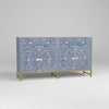 Decorative cabinet with blue and white pattern on a wooden floor.