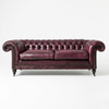 A classic Chesterfield loveseat sofa upholstered in deep burgundy leather, featuring button tufting, rolled arms, and dark wooden legs, photographed against a plain white studio background.