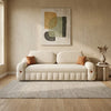 Beige sofa in a living room with abstract art on the wall