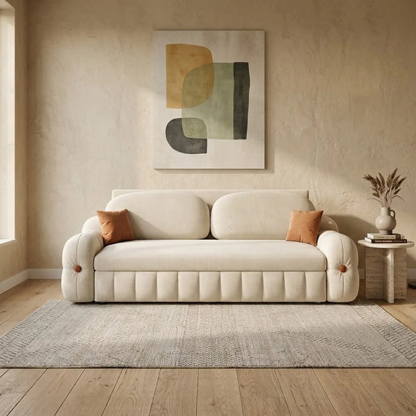 Beige sofa in a living room with abstract art on the wall