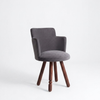 Gray upholstered chair with wooden legs on a white background